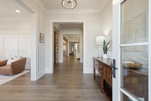 hallway with crown molding and dark hardwood / wood-style flooring