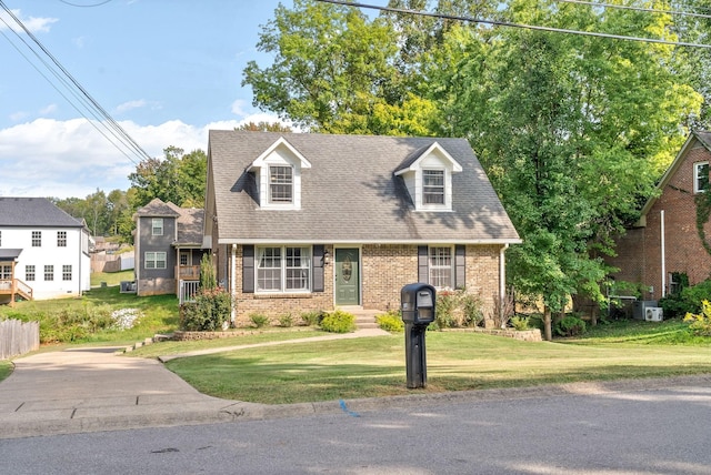 cape cod-style house featuring a front yard