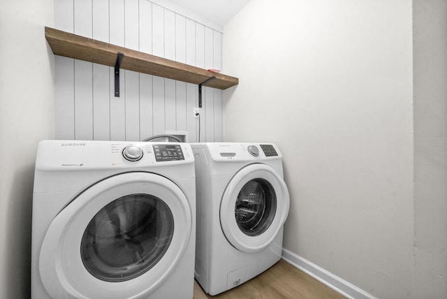 washroom featuring separate washer and dryer and light hardwood / wood-style floors