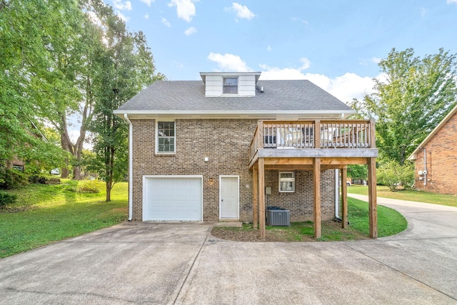 view of front of home with cooling unit, a garage, a deck, and a front yard