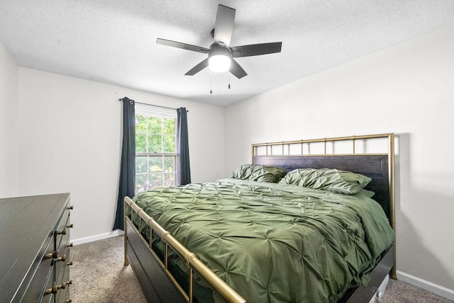 carpeted bedroom featuring a textured ceiling and ceiling fan