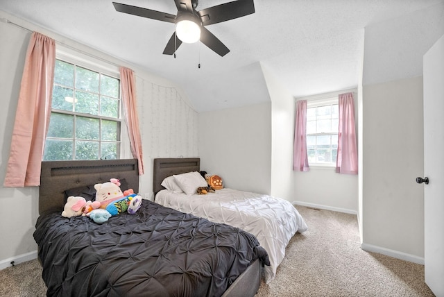 bedroom featuring ceiling fan, lofted ceiling, and light carpet