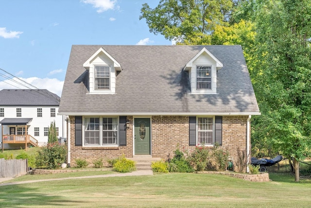 cape cod-style house with a front lawn