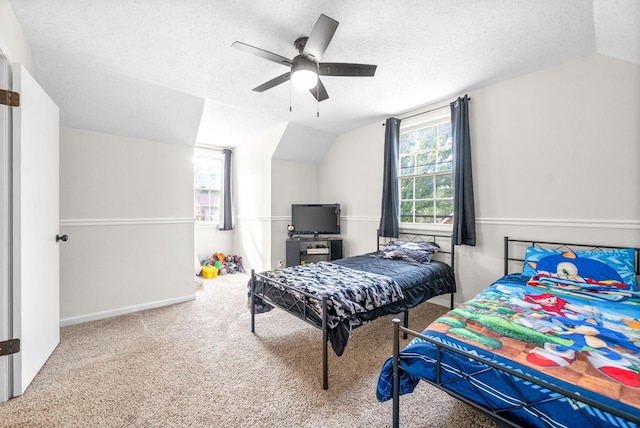 bedroom with lofted ceiling, multiple windows, ceiling fan, and carpet flooring