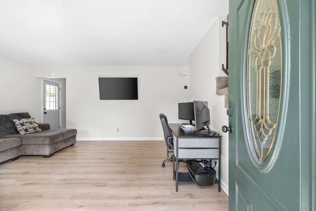 office area with light hardwood / wood-style floors