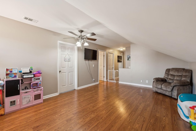 living room featuring hardwood / wood-style flooring, vaulted ceiling, and ceiling fan