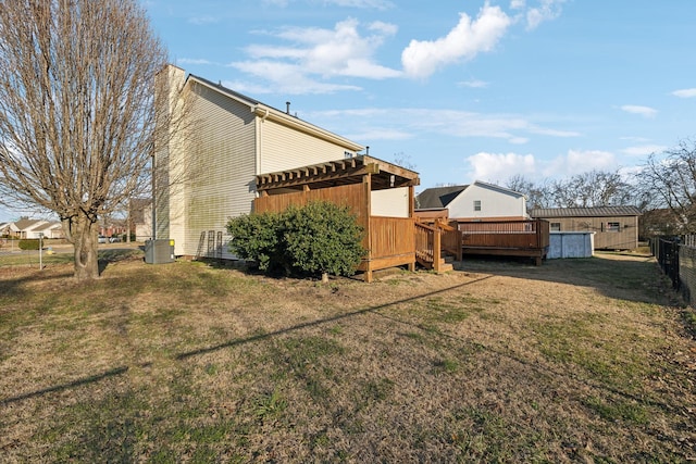 view of yard with cooling unit and a wooden deck