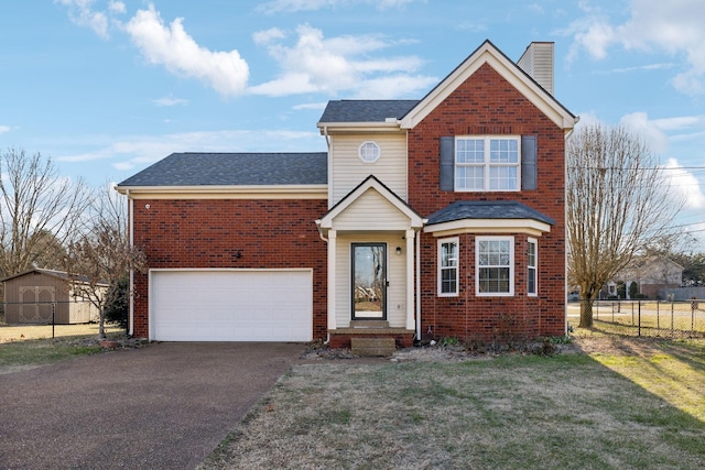 view of front property featuring a garage and a front lawn