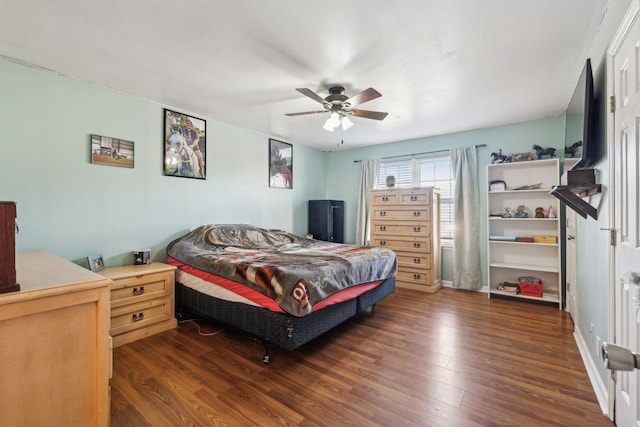 bedroom with dark hardwood / wood-style flooring and ceiling fan