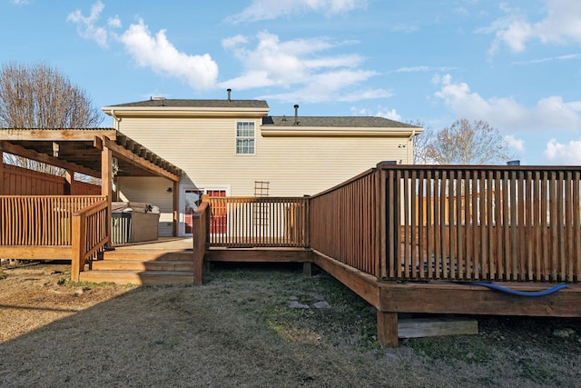 rear view of property featuring a wooden deck