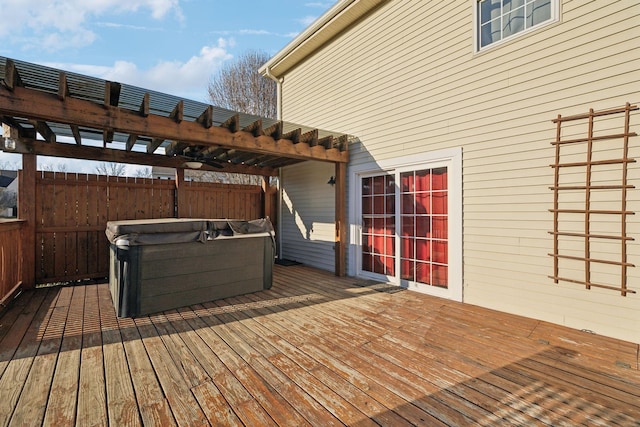 wooden terrace with a hot tub and a pergola