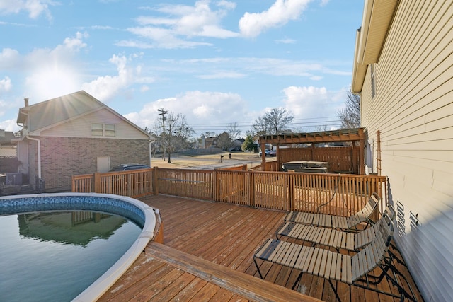 wooden deck featuring a swimming pool with hot tub