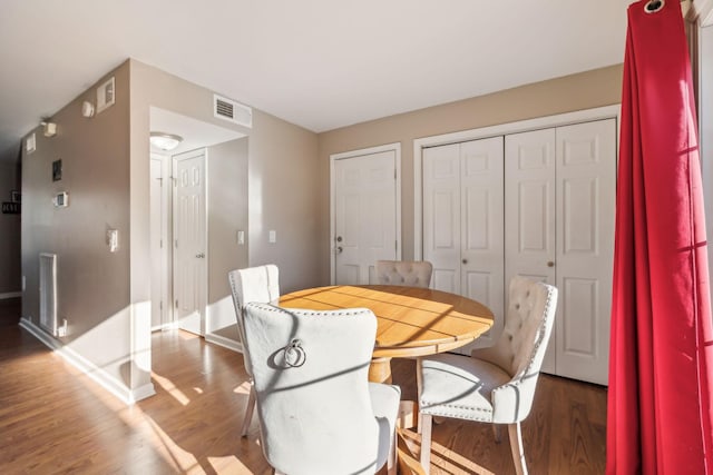 dining space featuring dark hardwood / wood-style flooring