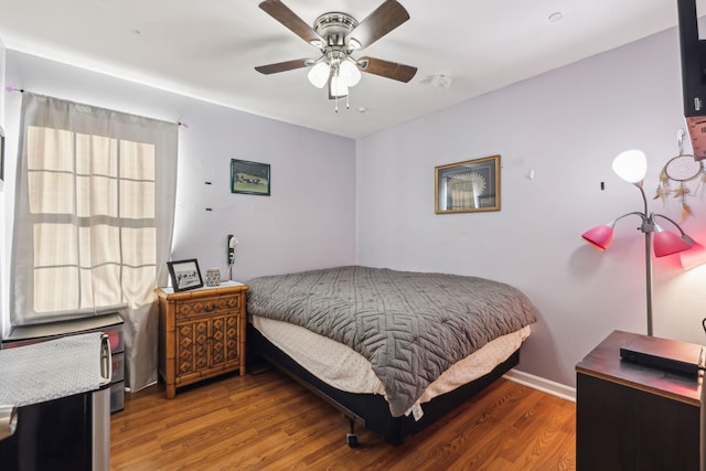 bedroom with ceiling fan and dark hardwood / wood-style floors