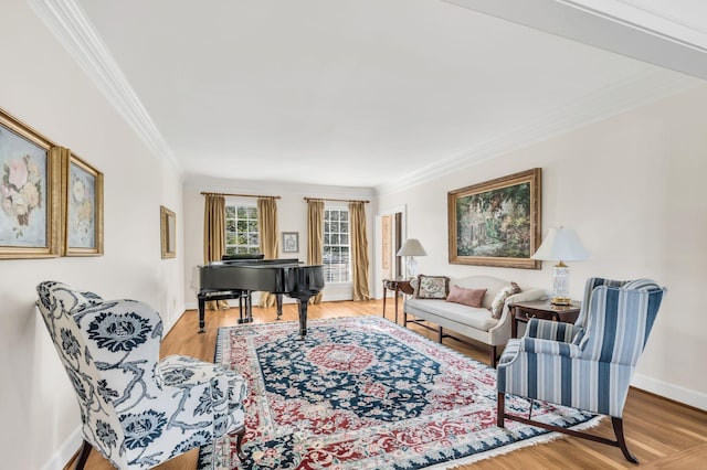 sitting room with crown molding and wood-type flooring