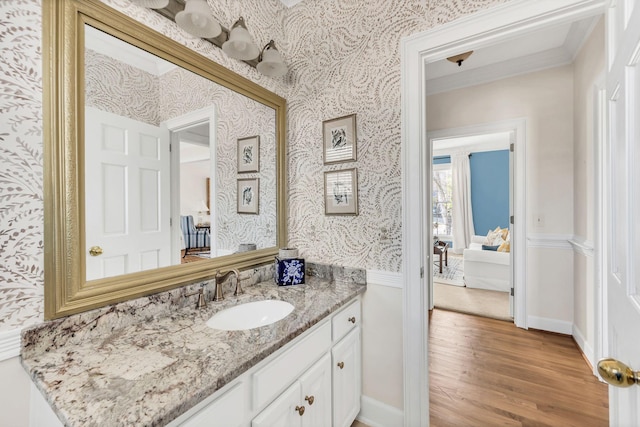 bathroom with vanity, ornamental molding, and hardwood / wood-style floors