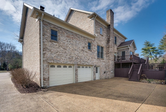 view of home's exterior with a garage and a deck