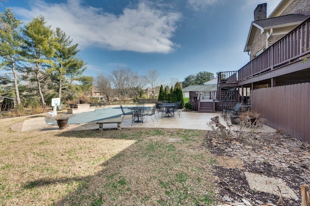 view of yard featuring a wooden deck and a patio area