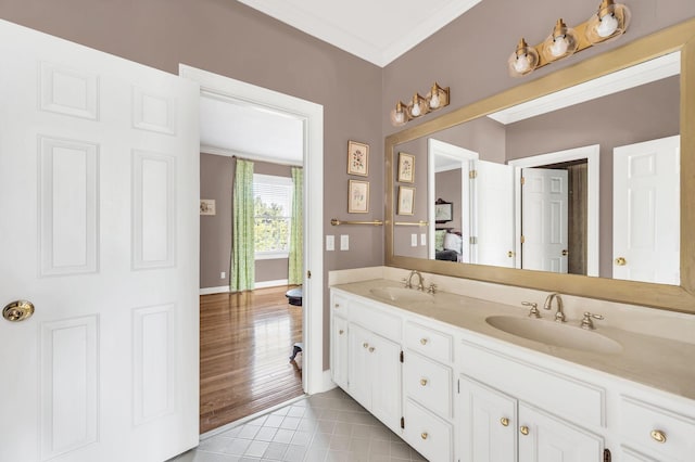 bathroom with ornamental molding, tile patterned flooring, and vanity