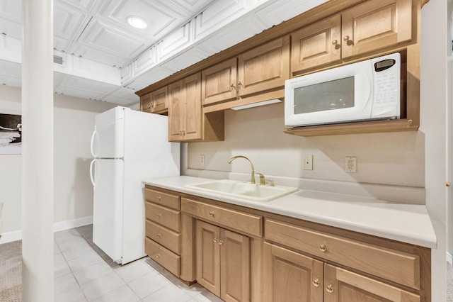 kitchen featuring light tile patterned flooring, sink, and white appliances