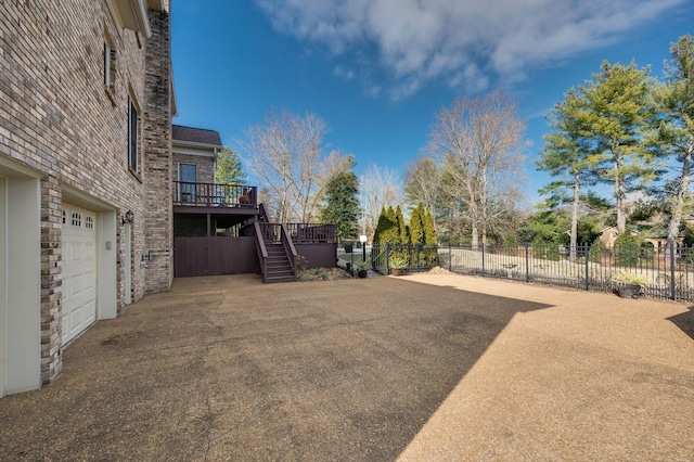 view of yard with a wooden deck and a garage