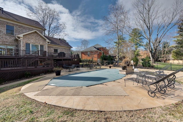 view of swimming pool with a wooden deck and a patio area