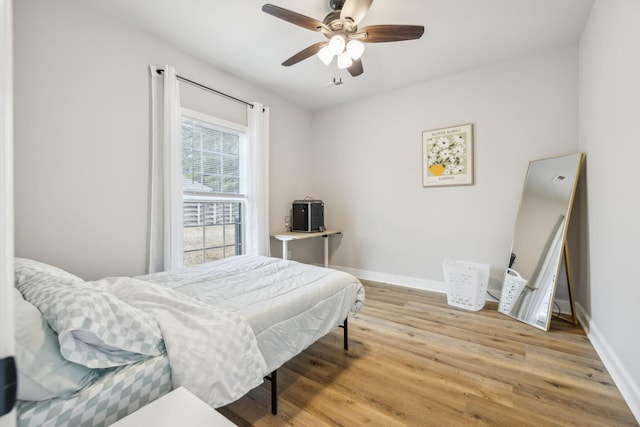 bedroom with hardwood / wood-style floors and ceiling fan