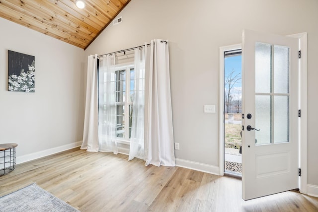 entrance foyer featuring a wealth of natural light, wooden ceiling, and light hardwood / wood-style floors