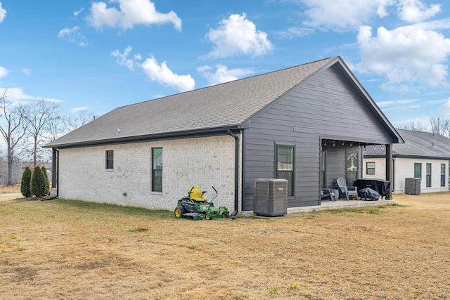 back of house with a lawn, a patio area, and central air condition unit