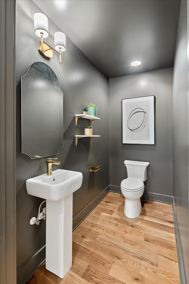 bathroom featuring wood-type flooring and toilet