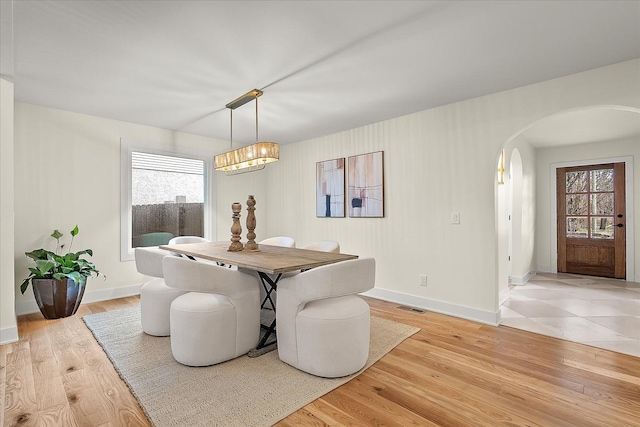 dining space featuring a wealth of natural light and light wood-type flooring