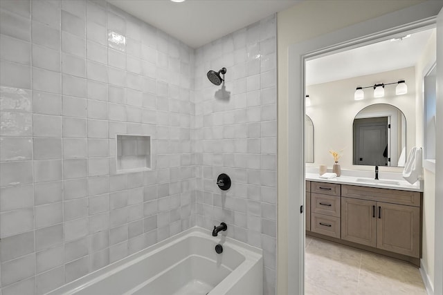 bathroom featuring vanity, tile patterned floors, and tiled shower / bath