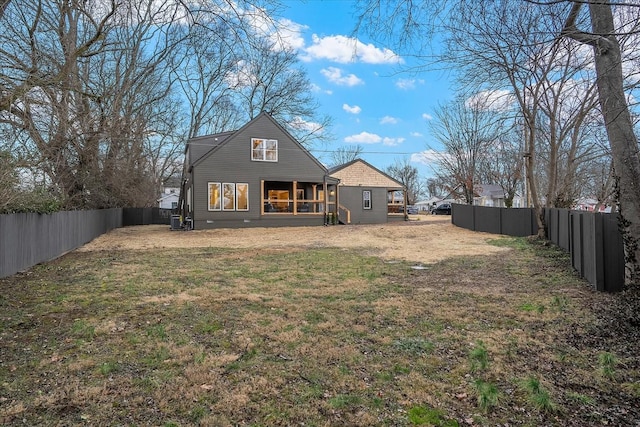 back of property featuring a yard and central air condition unit