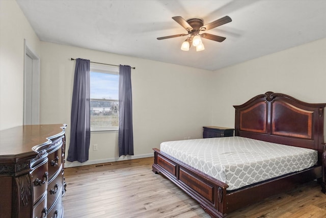 bedroom with light hardwood / wood-style floors and ceiling fan