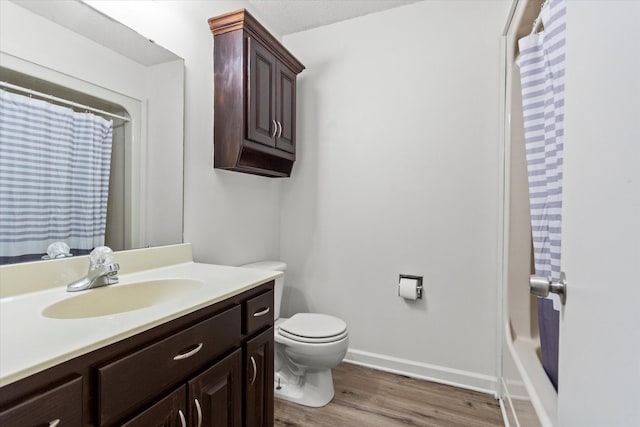 bathroom featuring vanity, hardwood / wood-style flooring, and toilet