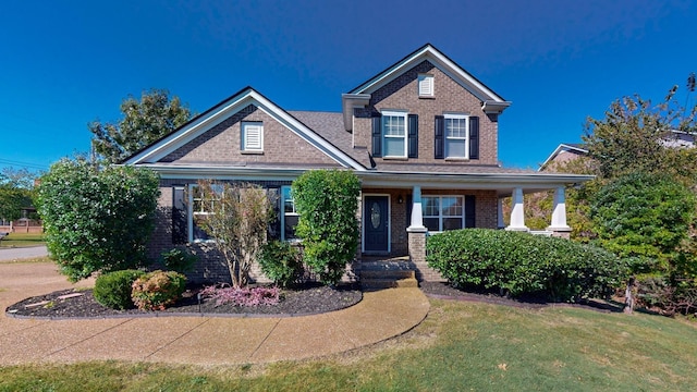 view of front of property with a porch and a front yard