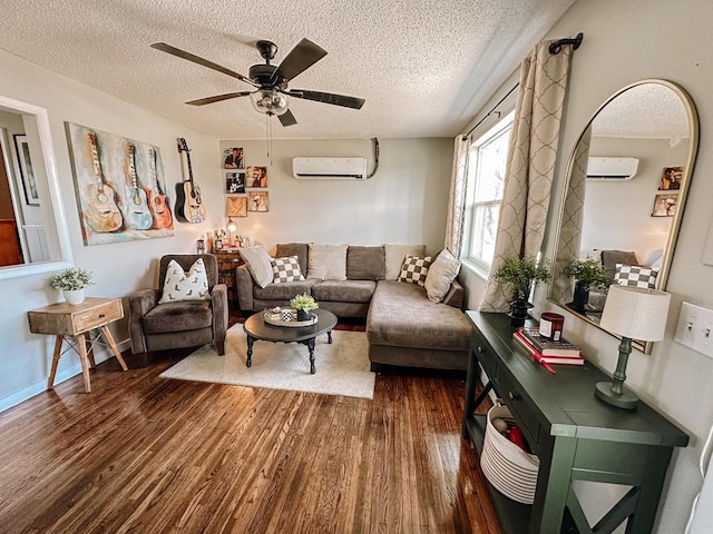 living room with dark wood-type flooring, a textured ceiling, and a wall unit AC