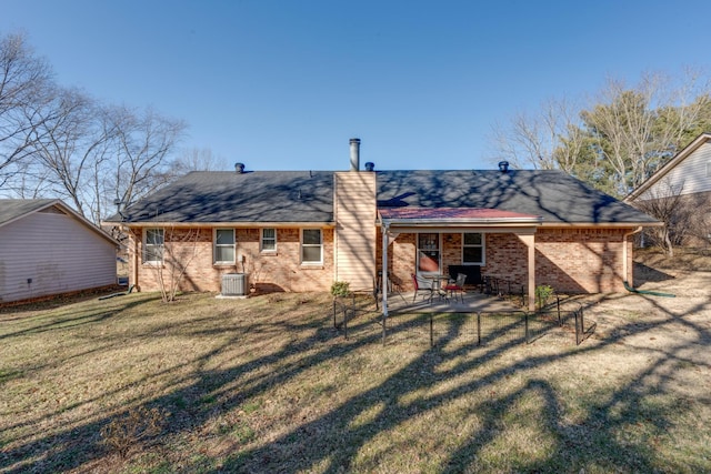 back of house featuring a lawn, a patio, and central air condition unit