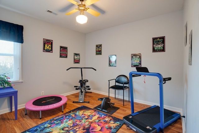 workout room featuring wood-type flooring and ceiling fan