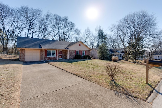 ranch-style home with a garage and a front lawn