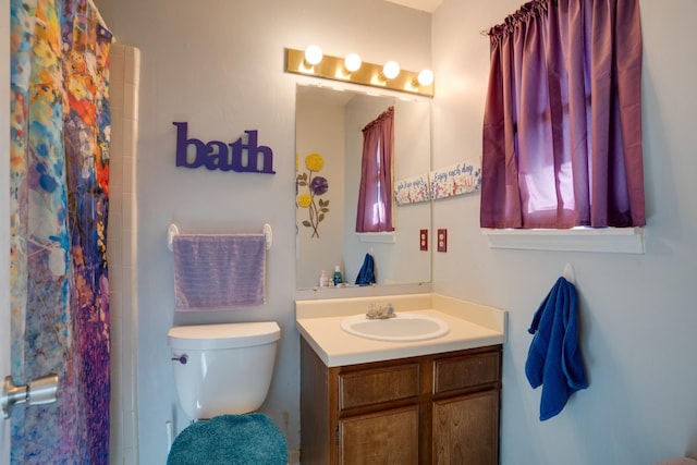 bathroom featuring vanity, a shower with curtain, and toilet