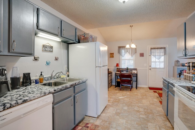 kitchen with gray cabinets, sink, hanging light fixtures, white appliances, and a textured ceiling