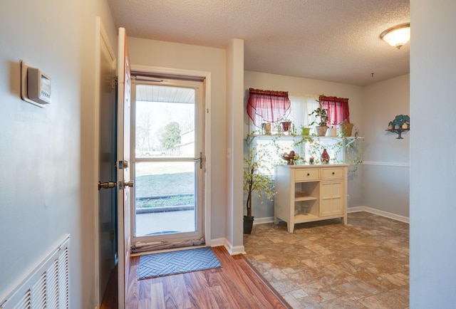 entryway featuring a textured ceiling