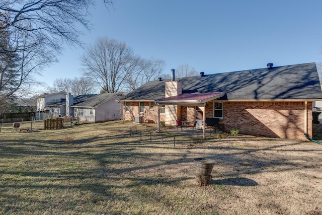 rear view of property with a yard