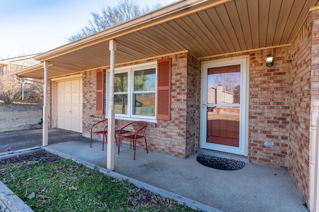 entrance to property featuring a porch and a garage