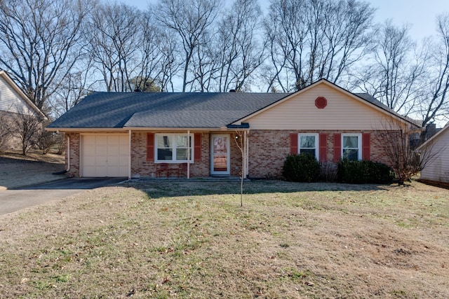 ranch-style home featuring a garage and a front lawn