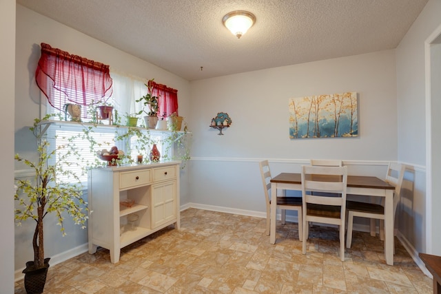 dining room with a textured ceiling