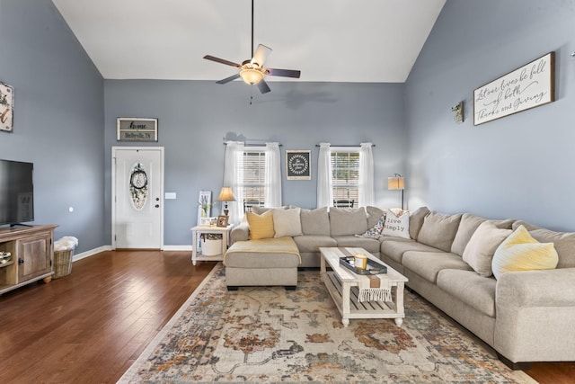 living room featuring dark wood-type flooring, high vaulted ceiling, and ceiling fan