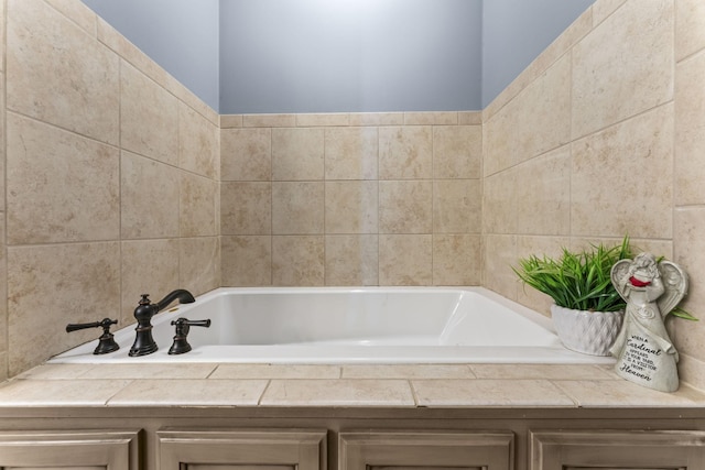 bathroom featuring tile walls and tiled tub