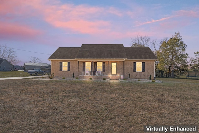 view of front of house featuring a yard and covered porch